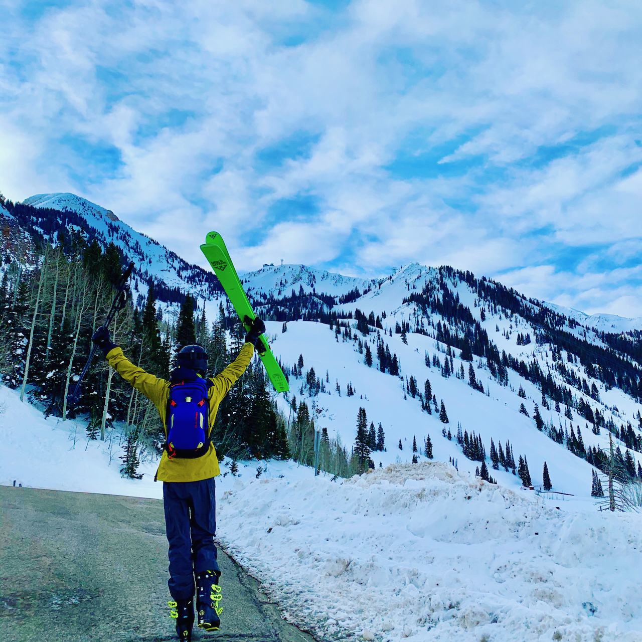 Matt walking up to Snowbird Ski Resort in Utah with his hands raised in the air in excitement.